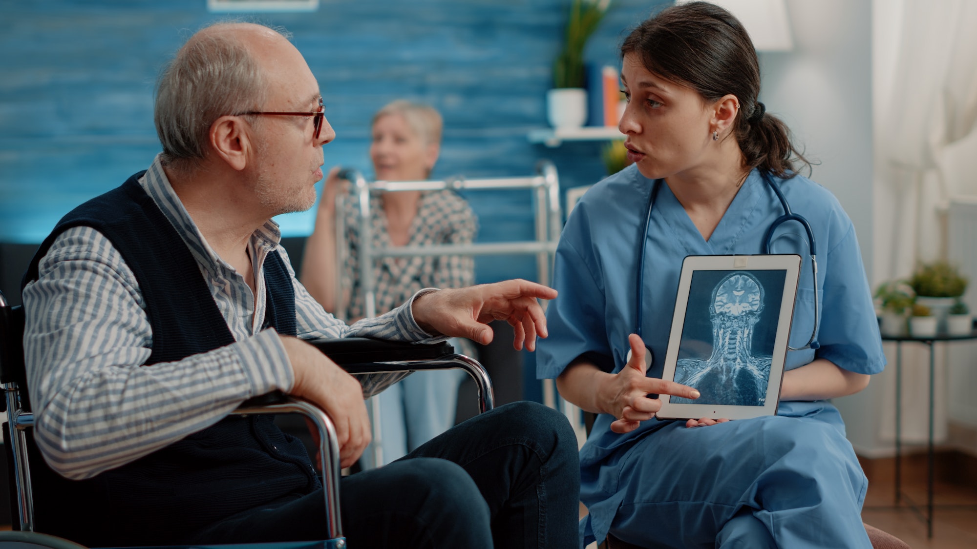 Medical assistant holding tablet with x ray scan for checkup